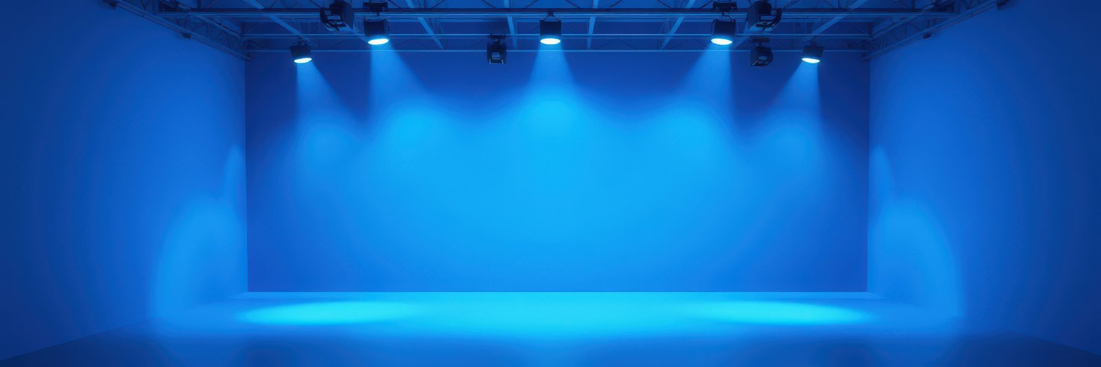 Blue lighting sets a dramatic ambiance in an empty performance space for future events and productions